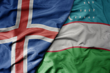 big waving national colorful flag of icelandic and national flag of uzbekistan .