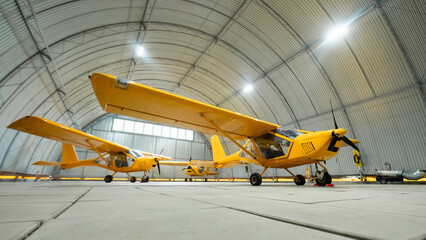 Yellow airplane glider in the hangar. 