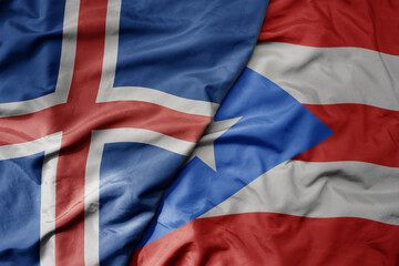 big waving national colorful flag of icelandic and national flag of puerto rico .