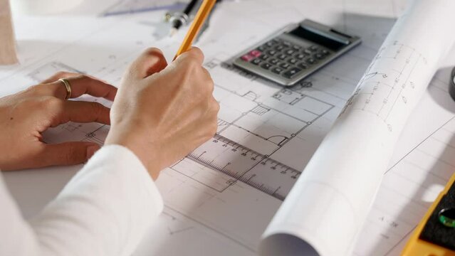 Architectural project workplace. Architect drawing with ruler on house plan blueprint paper for repair tools on table desk at architecture office, architect sketching construction, Engineering tools