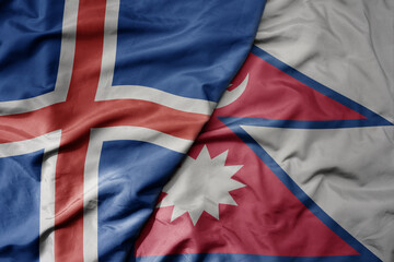 big waving national colorful flag of icelandic and national flag of nepal .