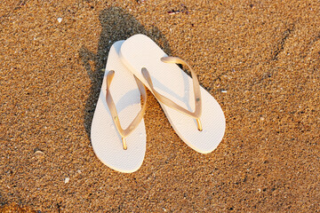 Stylish flips flops on sand at resort