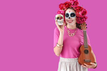 Young woman with painted skull and guitar on purple background. Mexico's Day of the Dead (El Dia de Muertos) celebration