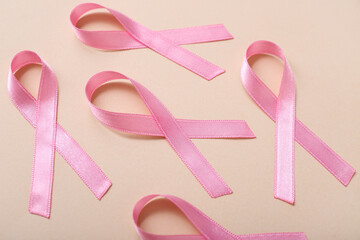Pink ribbons on beige background. Breast cancer awareness concept