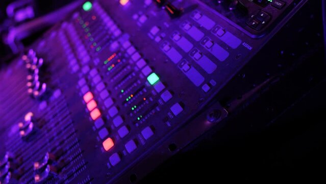 Closeup of sound mixer console music equipment during live band performance concert
