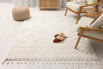 Fototapeta na wymiar Slippers on soft white carpet in living room