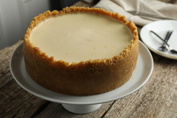 Tasty vegan tofu cheesecake on wooden table