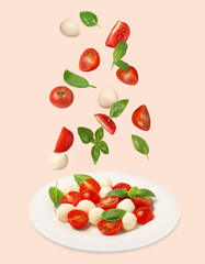 Fresh tomatoes. mozzarella cheese and basil leaves falling onto plate with Caprese salad against pink background