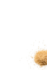 Close-up of a heap of organic raw brown sugar isolated on a white background from above, top view