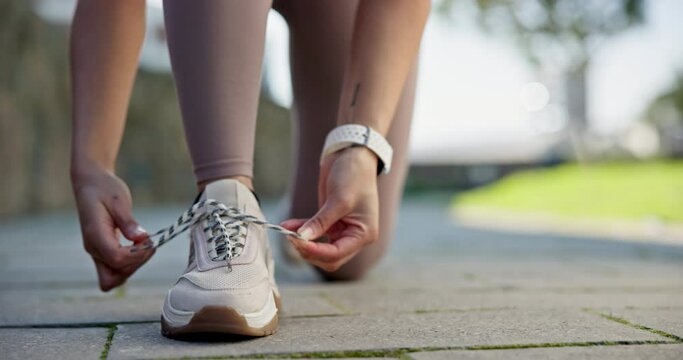 Fitness, shoes and hands on woman with lace tie in a road for running, workout and training outdoor. Start, feet and female runner prepare for wellness workout, performance and weekend sports routine