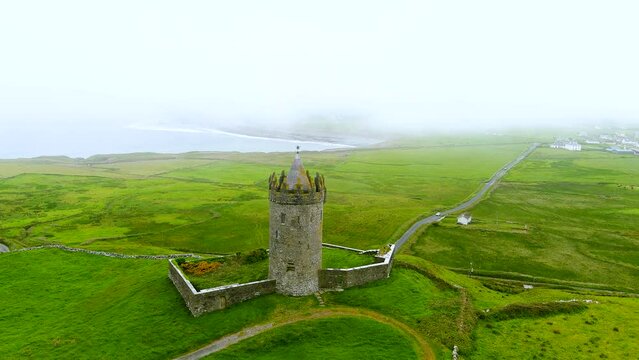 Aerial foggy view of Doonagore Castle, iconic landmark, County Clare, Ireland