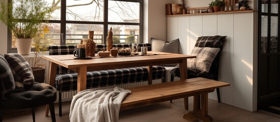 Plaid bench near kitchen counter and dining table, with a window and small terrace.
