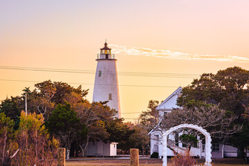 Ocracoke Lighthouse on Ocracoke Island , North Carolina at sunset.The lighthouse was built to help...
