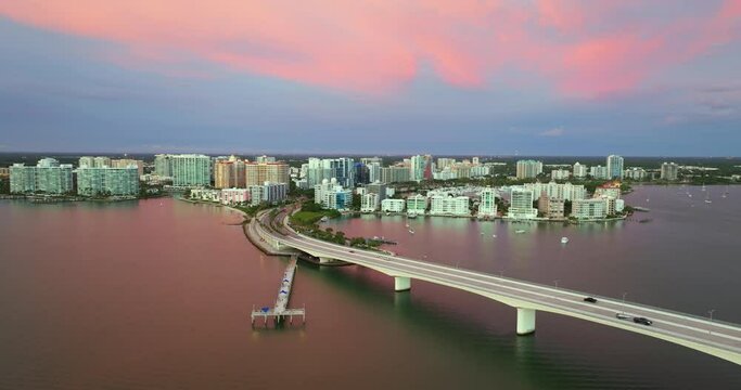 Sarasota city downtown at sunset. Ringling Bridge and expensive waterfront high-rise buildings in Florida. Urban travel destination in the USA