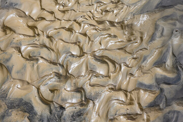 Patterns in wet volcanic mud as a nature background
