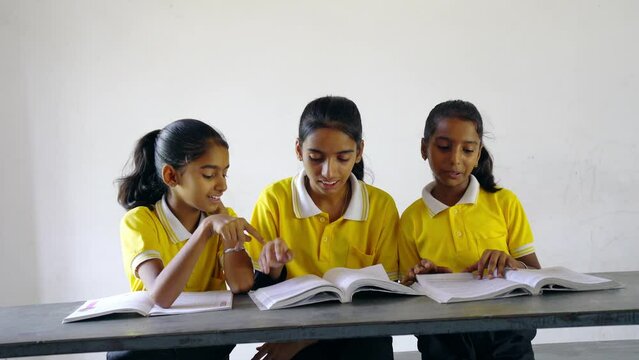 Group of teenage Village girl kids in school uniform holding book - concept of development, education and girl kid development