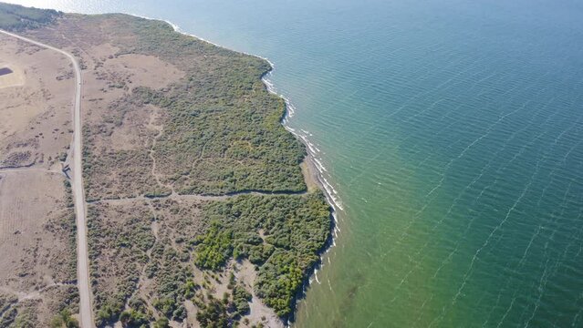 Forward reveal aerial shot of Sevan Lake on sunny summer day. Artsvanist, Gegharkunik Province, Armenia.