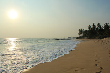 Beach with golden sand and blue ocean water on most popular unawatuna