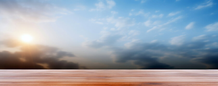 Wooden table top on blue sky background with clouds and sun. High quality photo