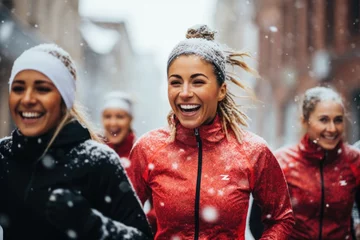 Foto op Plexiglas Smiling portrait of a young and diverse group of female friends jogging during the winter and snow in the city © Geber86