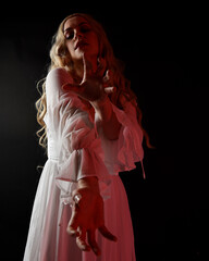 Close up portrait of scary blonde  vampire bride wearing elegant  white halloween fantasy gown....