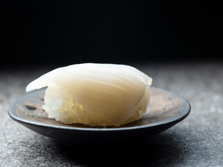 Raw squid sushi on plate	
