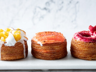 Assorted croissant donuts on a marble background