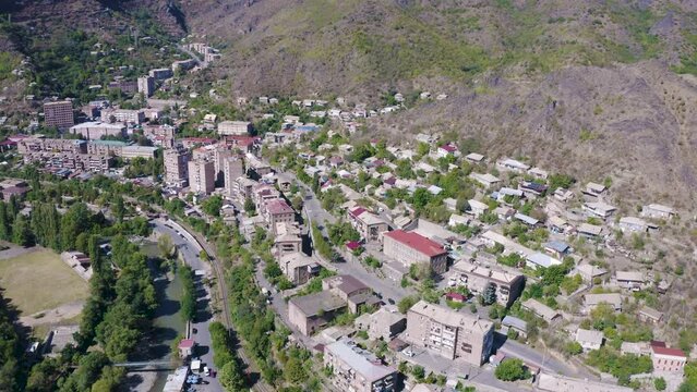 Forward reveal aerial shot of Alaverdi town on sunny summer day. Lori Province, Armenia.