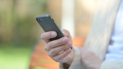 Close up of Male Hand using Smartphone Outdoor