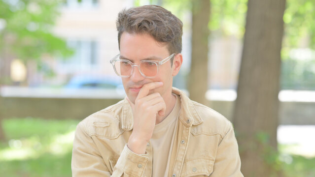 Outdoor Portrait of Brainstorming Casual Young Man with an Idea - Powered by Adobe