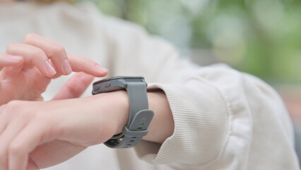 Close up of Woman Using  Smart Watch Outdoor