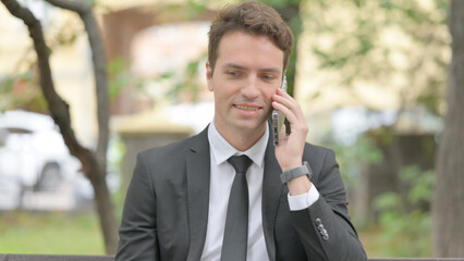 Busy Businessman Talking on Phone Outdoor