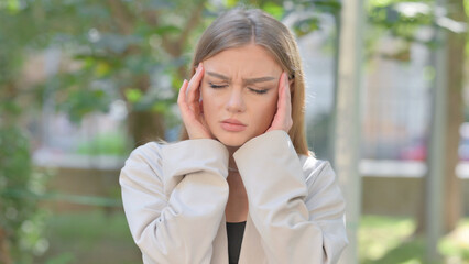 Outdoor Portrait of Businesswoman with Headache