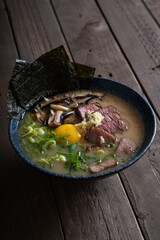 wagyu steak with fresh shitake mushroom and egg yolk in pork broth ramen