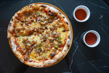 a gourmet sisig pizza that combine two most delicious cuisine, sisig and pizza 