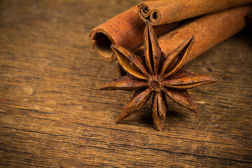 Close up of cinnamon sticks and star anise on wood