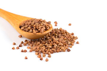 Uncooked buckwheat on wooden spoon