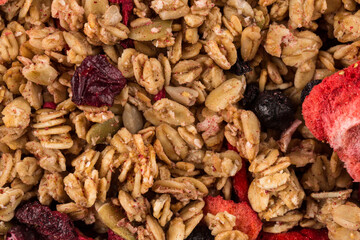 Muesli oat cereals close up background with dry fruits