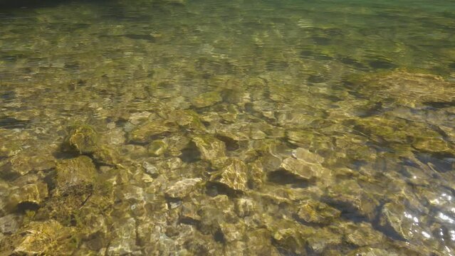 Clear, fresh mountain river water, glistening in the sun