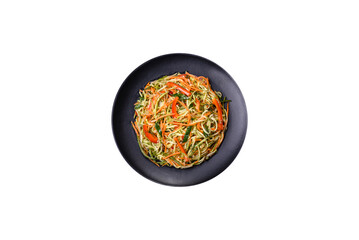 Fresh salad of sliced thin strips of carrot and zucchini on a concrete background