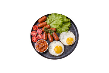 Traditional English breakfast with eggs, toast, sausages, beans, spices and herbs on a grey ceramic plate