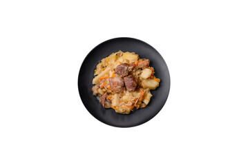 Delicious vegetable stew with beef, potatoes, carrots and cabbage in a black plate