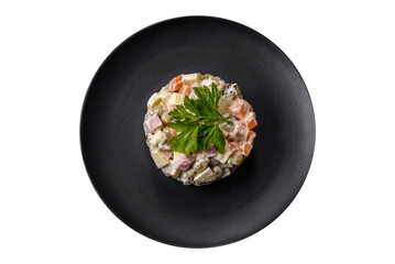 Delicious fresh Olivier salad with sausage, egg, cucumber, green peas, carrots and mayonnaise