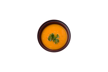 Delicious hot pumpkin and carrot soup puree with spices and herbs