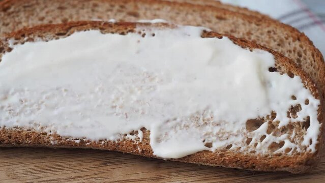 cream cheese spread on a bread on table 