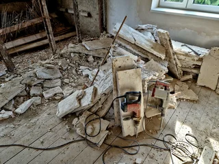 Stoff pro Meter demolition of the attic of an old house. partitions made of boards and bricks were destroyed by a team with pneumatic hammers. it looks like it was hit by a missile or an earthquake. © Michal