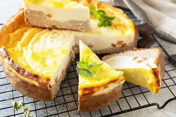 Cottage cheese casserole with raisins and chocolate on grey stone background. Ricotta cheesecake or casserole.