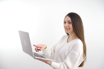 Asian beautiful woman Standing in a white shirt in her hand Holding a laptop computer Stand smiling happily With a white background. High quality photo