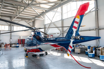 The passenger helicopter in the aviation hangar. Back view © Dushlik