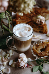 homemade apple pie with a cup of cappuccino and flowers